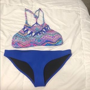 blue bathing suit bottoms with a colorful blue top